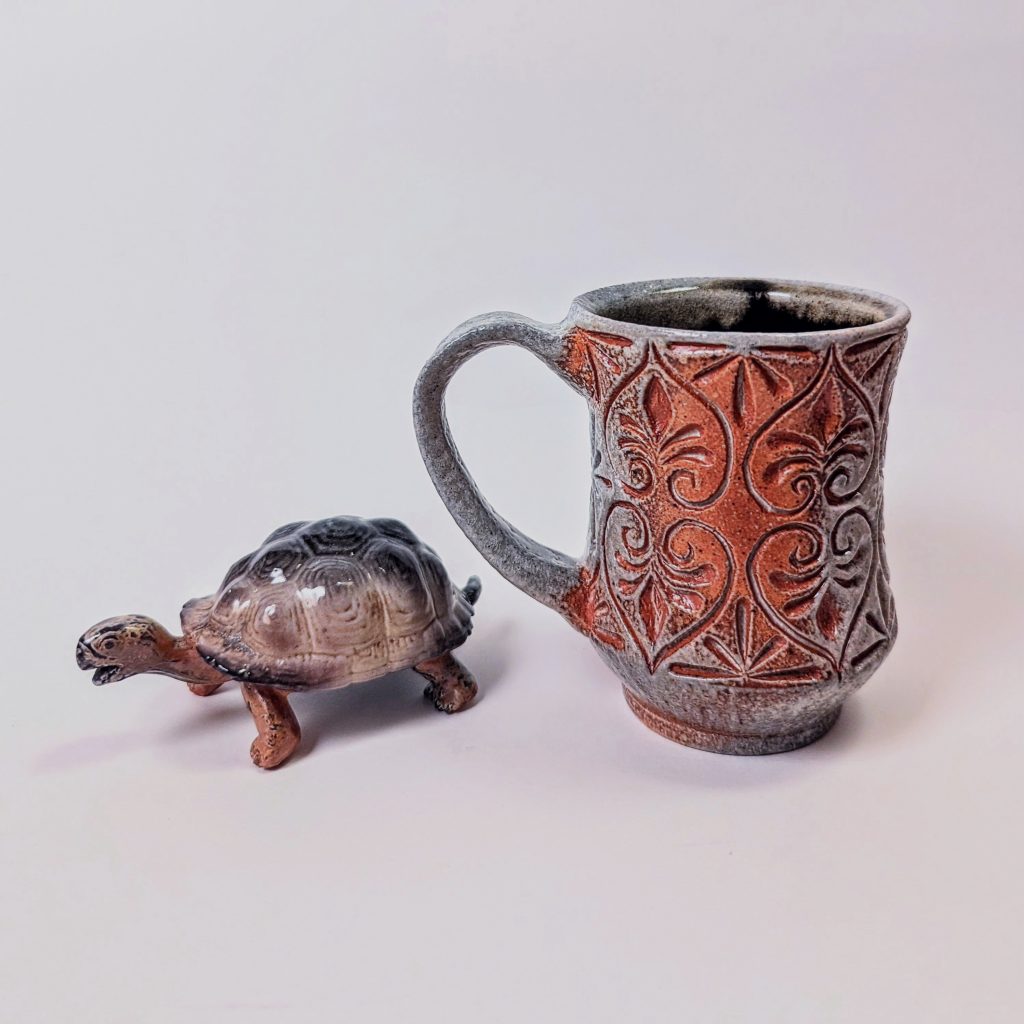 Carved Mug with turtle, soda fired 
